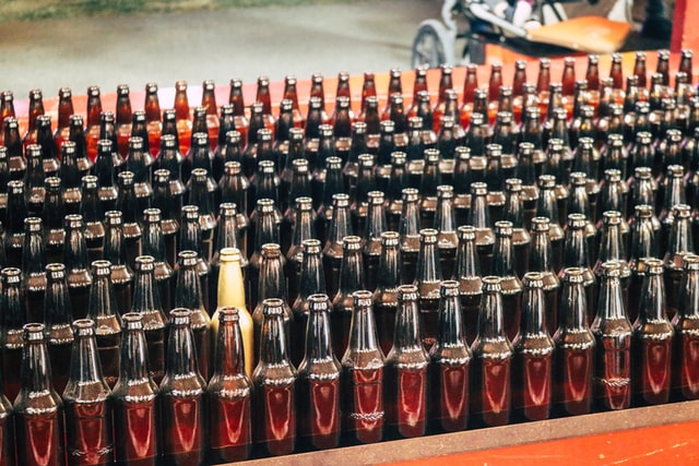 amber bottle standing out in a crowd of brown bottles